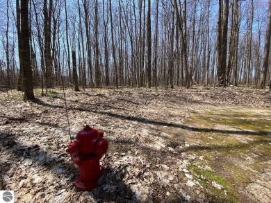 Towering hardwoods in a quiet cul-de-sac location and a large on Cedar River Golf Course in Michigan - for sale on GolfHomes.com, golf home, golf lot