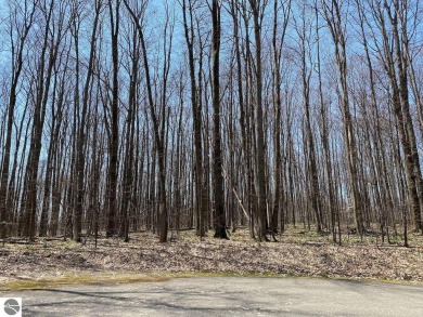 Towering hardwoods in a quiet cul-de-sac location and a large on Cedar River Golf Course in Michigan - for sale on GolfHomes.com, golf home, golf lot