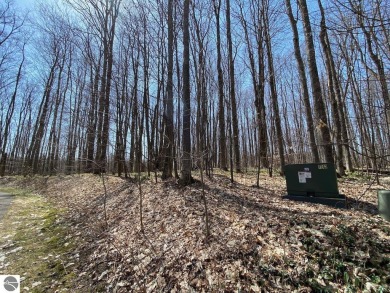 Towering hardwoods in a quiet cul-de-sac location and a large on Cedar River Golf Course in Michigan - for sale on GolfHomes.com, golf home, golf lot