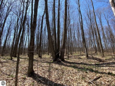 Towering hardwoods in a quiet cul-de-sac location and a large on Cedar River Golf Course in Michigan - for sale on GolfHomes.com, golf home, golf lot