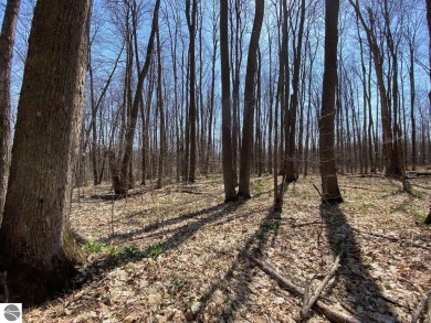 Towering hardwoods in a quiet cul-de-sac location and a large on Cedar River Golf Course in Michigan - for sale on GolfHomes.com, golf home, golf lot