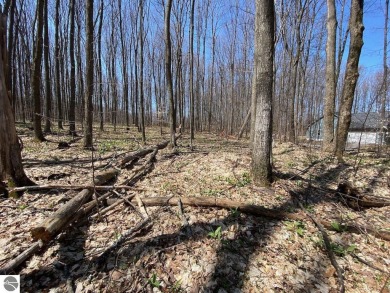 Towering hardwoods in a quiet cul-de-sac location and a large on Cedar River Golf Course in Michigan - for sale on GolfHomes.com, golf home, golf lot