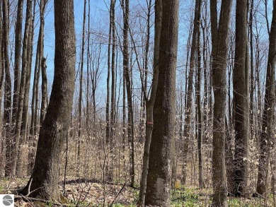 Towering hardwoods in a quiet cul-de-sac location and a large on Cedar River Golf Course in Michigan - for sale on GolfHomes.com, golf home, golf lot