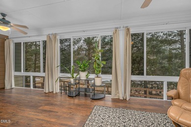 Set along the 13th green in The River subdivision of Lake Royale on River Golf and Country Club at Lake Royale in North Carolina - for sale on GolfHomes.com, golf home, golf lot