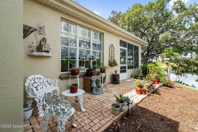 Enjoy stunning water views and abundant natural light in this on Viera East Golf Club in Florida - for sale on GolfHomes.com, golf home, golf lot