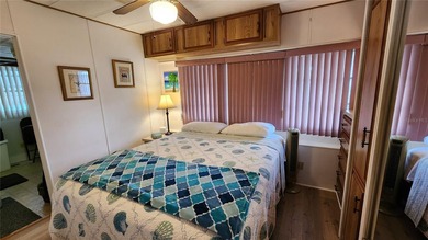TWO BEDROOM, ONE BATH MOBILE HOME IN ACTIVE 55+ COMMUNITY! This on River Run Golf Links in Florida - for sale on GolfHomes.com, golf home, golf lot