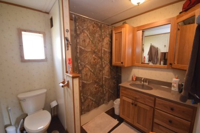 Two-bedroom one bath located on Roy Lake. 1991 14 x 50 mobile on Roy View Golf Course in South Dakota - for sale on GolfHomes.com, golf home, golf lot