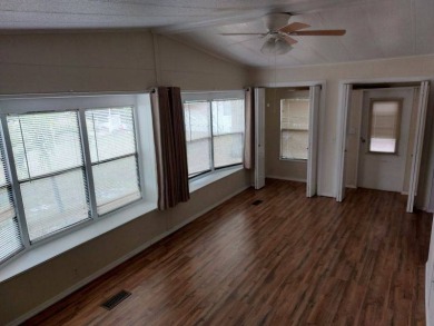 Lot Rent is $1,185.00 monthly. This is a 2-bedroom 2 bath on Lake Fairways Country Club in Florida - for sale on GolfHomes.com, golf home, golf lot