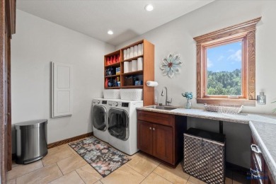 Tucked into nearly 3 acres of mature trees and peaceful hills on Spearfish Canyon Country Club in South Dakota - for sale on GolfHomes.com, golf home, golf lot