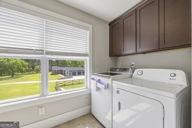 This exceptional six-bedroom, six-and-a-half-bathroom home sits on Lane Creek Golf Club in Georgia - for sale on GolfHomes.com, golf home, golf lot