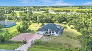 Welcome to your dream home! Nestled on a full acre of land in a on Wedgefield Golf Club in Florida - for sale on GolfHomes.com, golf home, golf lot