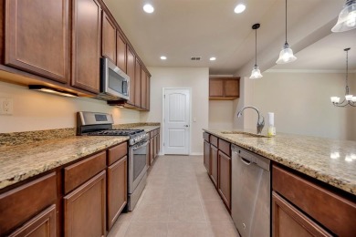 This beautifully maintained corner lot half duplex home is on Wildhorse Golf Club of Robson Ranch in Texas - for sale on GolfHomes.com, golf home, golf lot