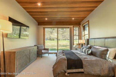 This mountain modern property is located on the Trumpeter Pond on Snake River Sporting Club in Wyoming - for sale on GolfHomes.com, golf home, golf lot