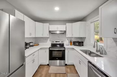 Beautifully updated 4-bedroom, 2-bath home in the highly on Twin Lakes Golf Course in North Carolina - for sale on GolfHomes.com, golf home, golf lot