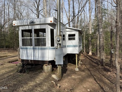 Discover the potential of this unique property located in the on River Golf and Country Club at Lake Royale in North Carolina - for sale on GolfHomes.com, golf home, golf lot