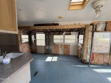 Discover the potential of this unique property located in the on River Golf and Country Club at Lake Royale in North Carolina - for sale on GolfHomes.com, golf home, golf lot