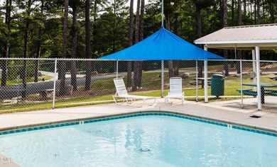 Beautiful 0.49-acre wooded lot located in the gated Lake Royale on River Golf and Country Club at Lake Royale in North Carolina - for sale on GolfHomes.com, golf home, golf lot