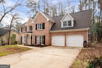 Stunning beauty surrounds this graceful home in Brookstone on Brookstone Golf and Country Club in Georgia - for sale on GolfHomes.com, golf home, golf lot