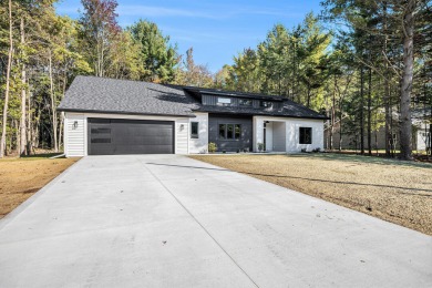 Discover your dream home with effortless living and modern on Oak Ridge Golf Club in Michigan - for sale on GolfHomes.com, golf home, golf lot