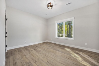 Discover your dream home with effortless living and modern on Oak Ridge Golf Club in Michigan - for sale on GolfHomes.com, golf home, golf lot