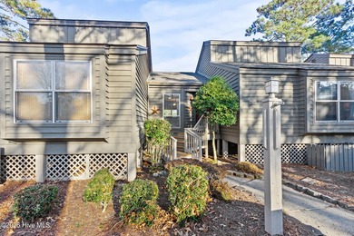 Set on a quiet street with peaceful views of Tradewinds Lake on Harbour Point Golf Club in North Carolina - for sale on GolfHomes.com, golf home, golf lot