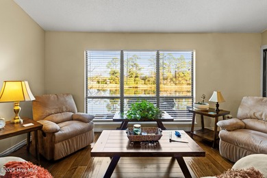 Set on a quiet street with peaceful views of Tradewinds Lake on Harbour Point Golf Club in North Carolina - for sale on GolfHomes.com, golf home, golf lot