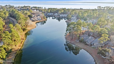 Set on a quiet street with peaceful views of Tradewinds Lake on Harbour Point Golf Club in North Carolina - for sale on GolfHomes.com, golf home, golf lot