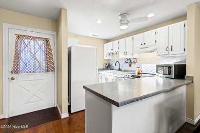 Set on a quiet street with peaceful views of Tradewinds Lake on Harbour Point Golf Club in North Carolina - for sale on GolfHomes.com, golf home, golf lot