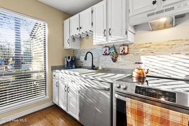 Set on a quiet street with peaceful views of Tradewinds Lake on Harbour Point Golf Club in North Carolina - for sale on GolfHomes.com, golf home, golf lot