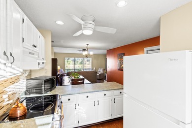 Set on a quiet street with peaceful views of Tradewinds Lake on Harbour Point Golf Club in North Carolina - for sale on GolfHomes.com, golf home, golf lot