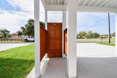 The home is elevated on pilings to allow for covered parking and on Rockport Country Club in Texas - for sale on GolfHomes.com, golf home, golf lot