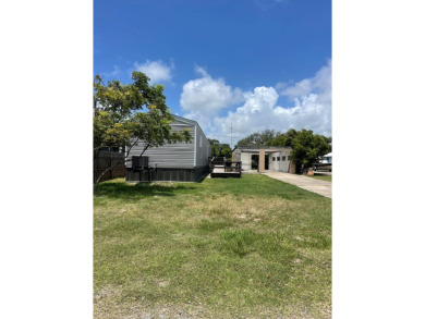 Discover this inviting 3-bedroom, 2-bathroom split-floorplan on Rockport Country Club in Texas - for sale on GolfHomes.com, golf home, golf lot
