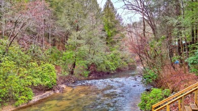 Nature abounds at this furnished cabin nestled on the banks of on White Path Golf Club in Georgia - for sale on GolfHomes.com, golf home, golf lot