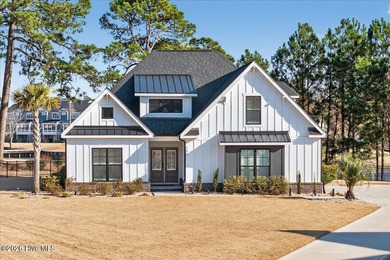 Step inside this luxury modern coastal craftsman home, perfectly on Sea Trail Golf Resort in North Carolina - for sale on GolfHomes.com, golf home, golf lot