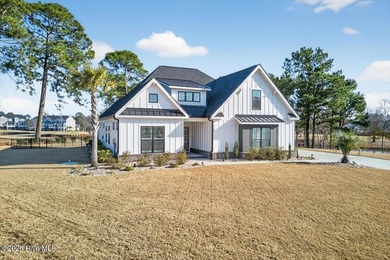 Step inside this luxury modern coastal craftsman home, perfectly on Sea Trail Golf Resort in North Carolina - for sale on GolfHomes.com, golf home, golf lot