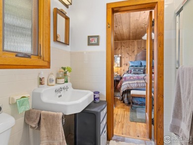 Step inside this charming rustic cabin that offers a peaceful on Estes Park Golf Course in Colorado - for sale on GolfHomes.com, golf home, golf lot