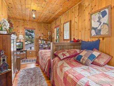 Step inside this charming rustic cabin that offers a peaceful on Estes Park Golf Course in Colorado - for sale on GolfHomes.com, golf home, golf lot