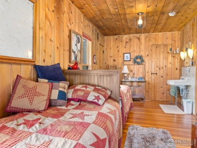 Step inside this charming rustic cabin that offers a peaceful on Estes Park Golf Course in Colorado - for sale on GolfHomes.com, golf home, golf lot