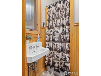 Step inside this charming rustic cabin that offers a peaceful on Estes Park Golf Course in Colorado - for sale on GolfHomes.com, golf home, golf lot
