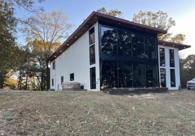 Experience the welcoming beauty of this two story Unrique Modern on Glenwood Country Club in Arkansas - for sale on GolfHomes.com, golf home, golf lot