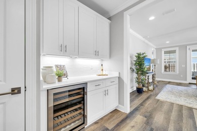 As you arrive at 304 Windrow Way, the corner-lot setting and on Origins Golf Club in Florida - for sale on GolfHomes.com, golf home, golf lot