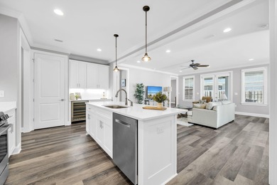 As you arrive at 304 Windrow Way, the corner-lot setting and on Origins Golf Club in Florida - for sale on GolfHomes.com, golf home, golf lot