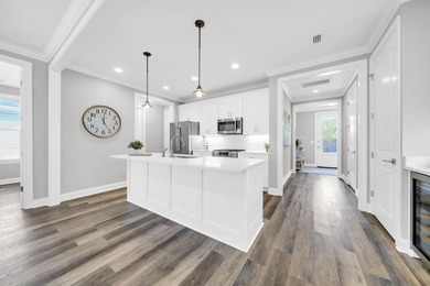 As you arrive at 304 Windrow Way, the corner-lot setting and on Origins Golf Club in Florida - for sale on GolfHomes.com, golf home, golf lot