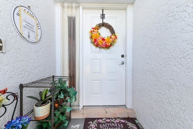 From the moment you approach, this radiant home invites you into on Cypress Lakes Golf Course - West Palm Beach in Florida - for sale on GolfHomes.com, golf home, golf lot