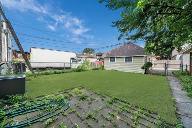 Charming brick bungalow offering 3 bedrooms, 1 full bath, a on Marquette Park Golf Course in Illinois - for sale on GolfHomes.com, golf home, golf lot