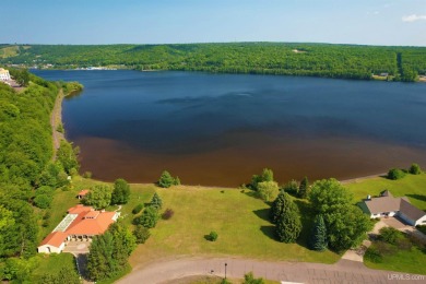 A rare opportunity to own Portage Lake waterfront property in on Portage Lake Golf Course in Michigan - for sale on GolfHomes.com, golf home, golf lot