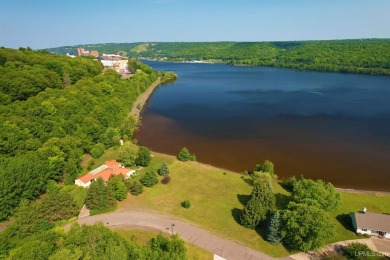 A rare opportunity to own Portage Lake waterfront property in on Portage Lake Golf Course in Michigan - for sale on GolfHomes.com, golf home, golf lot