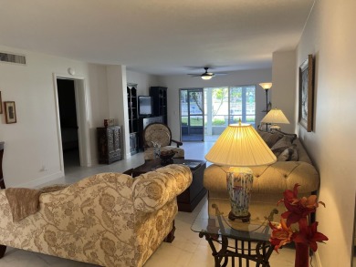 Very desirable bottom floor condo with views of the water, golf on Atlantis Golf Club in Florida - for sale on GolfHomes.com, golf home, golf lot