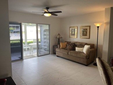 Very desirable bottom floor condo with views of the water, golf on Atlantis Golf Club in Florida - for sale on GolfHomes.com, golf home, golf lot