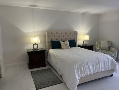 Very desirable bottom floor condo with views of the water, golf on Atlantis Golf Club in Florida - for sale on GolfHomes.com, golf home, golf lot